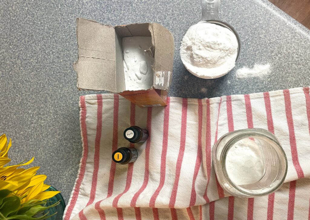 baking soda, essential oils, jar, on stripped tea towel