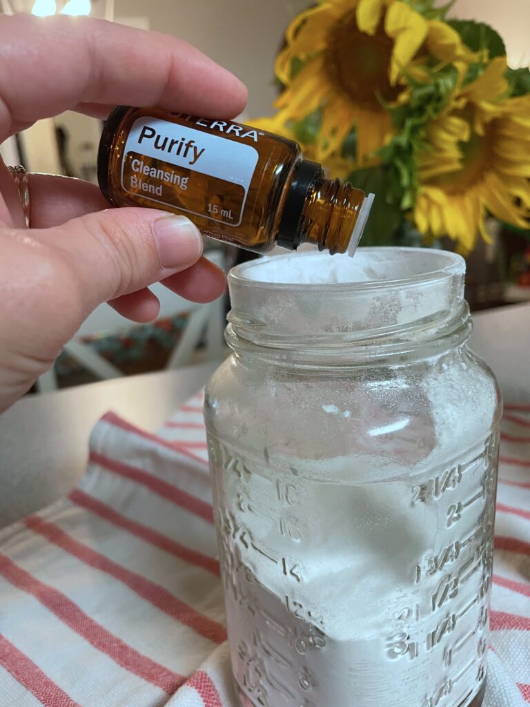 dropping essential oils into jar