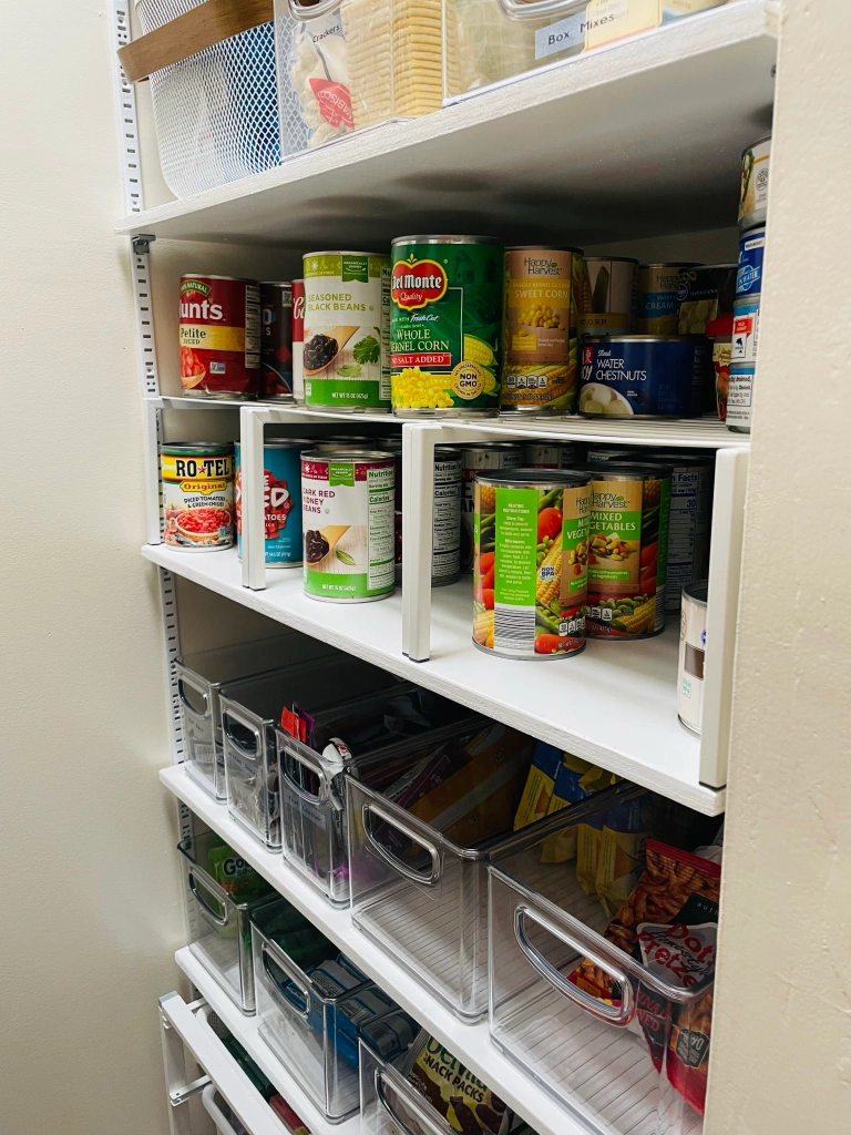 white wire shelves with canned good on top
