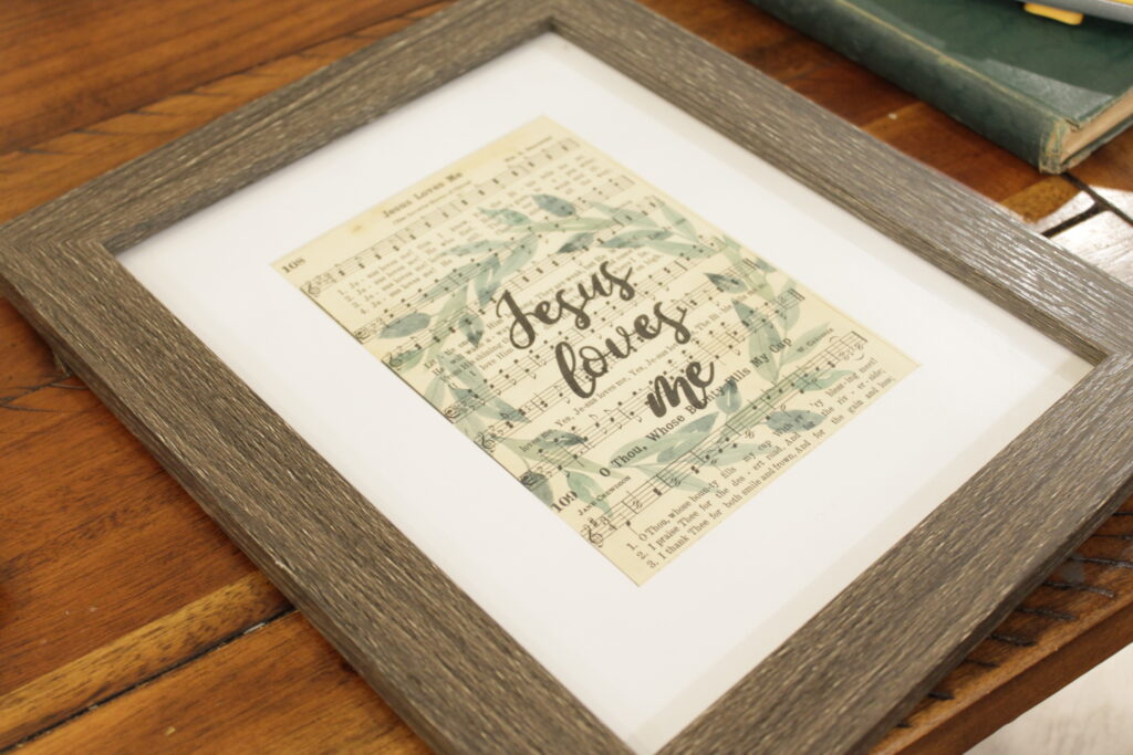 Jesus loves me in wooden frame