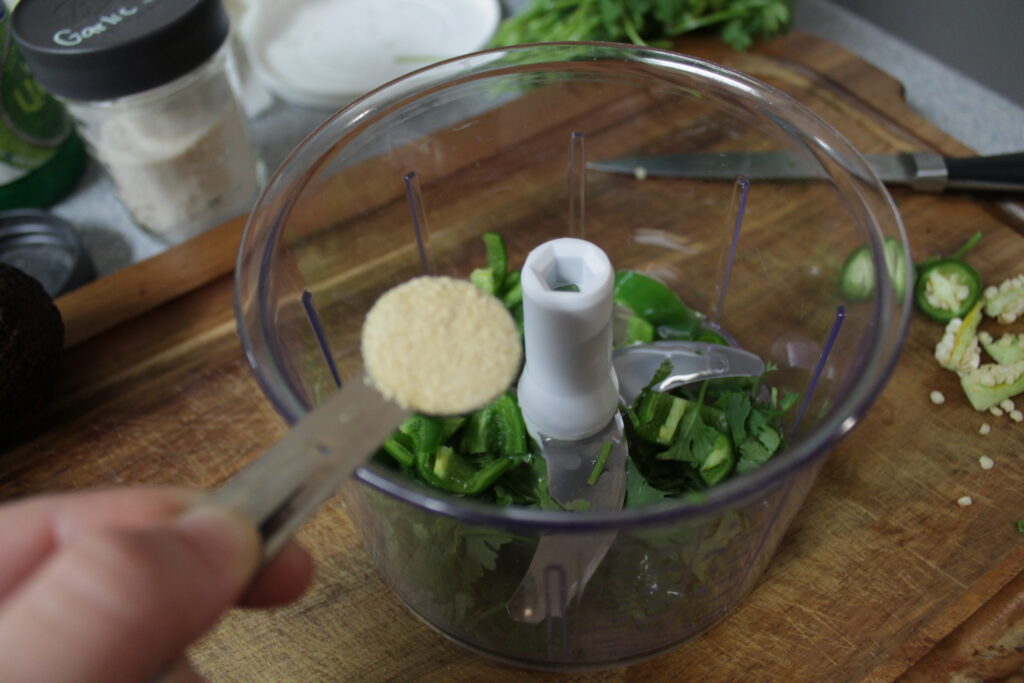 adding onion powder with teaspoon to food processor