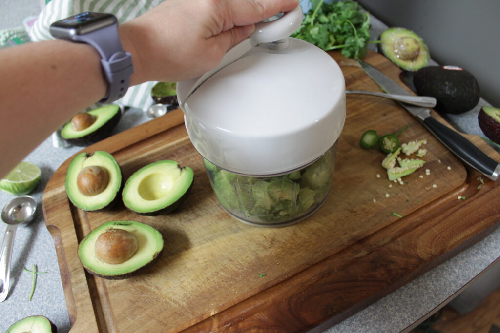 manually chopping guacamole ingredients in food processor
