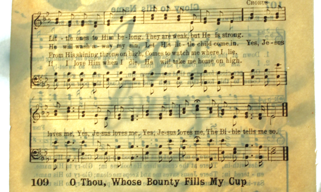 hymn paper with Jesus loves me text showing through