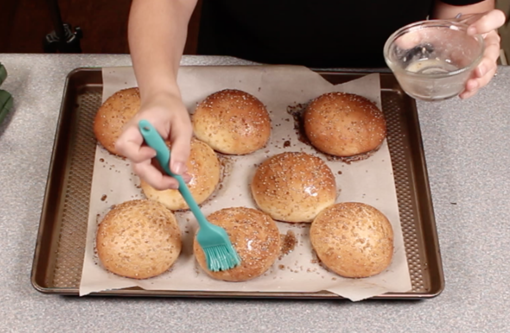 basting butter on baked hamburger buns