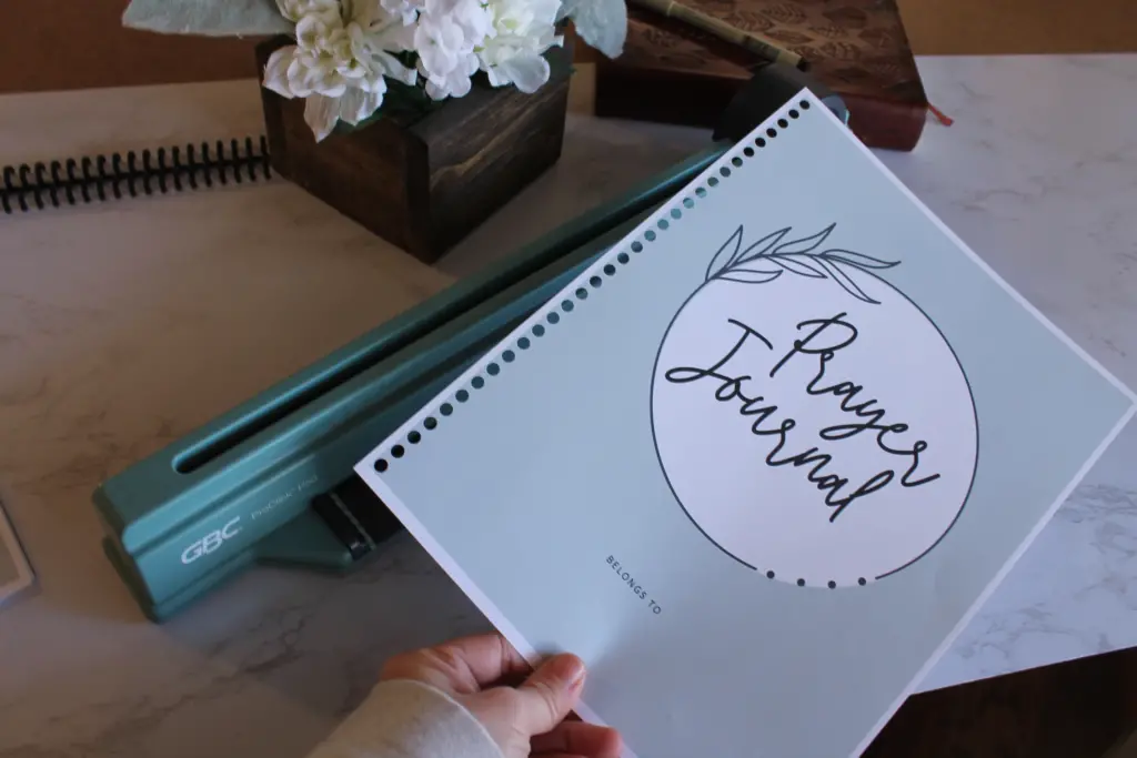 punching holes in the journal pages