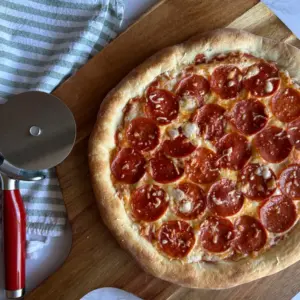 Potato Flake sourdough pizza with pepperoni toppings on pizza peel