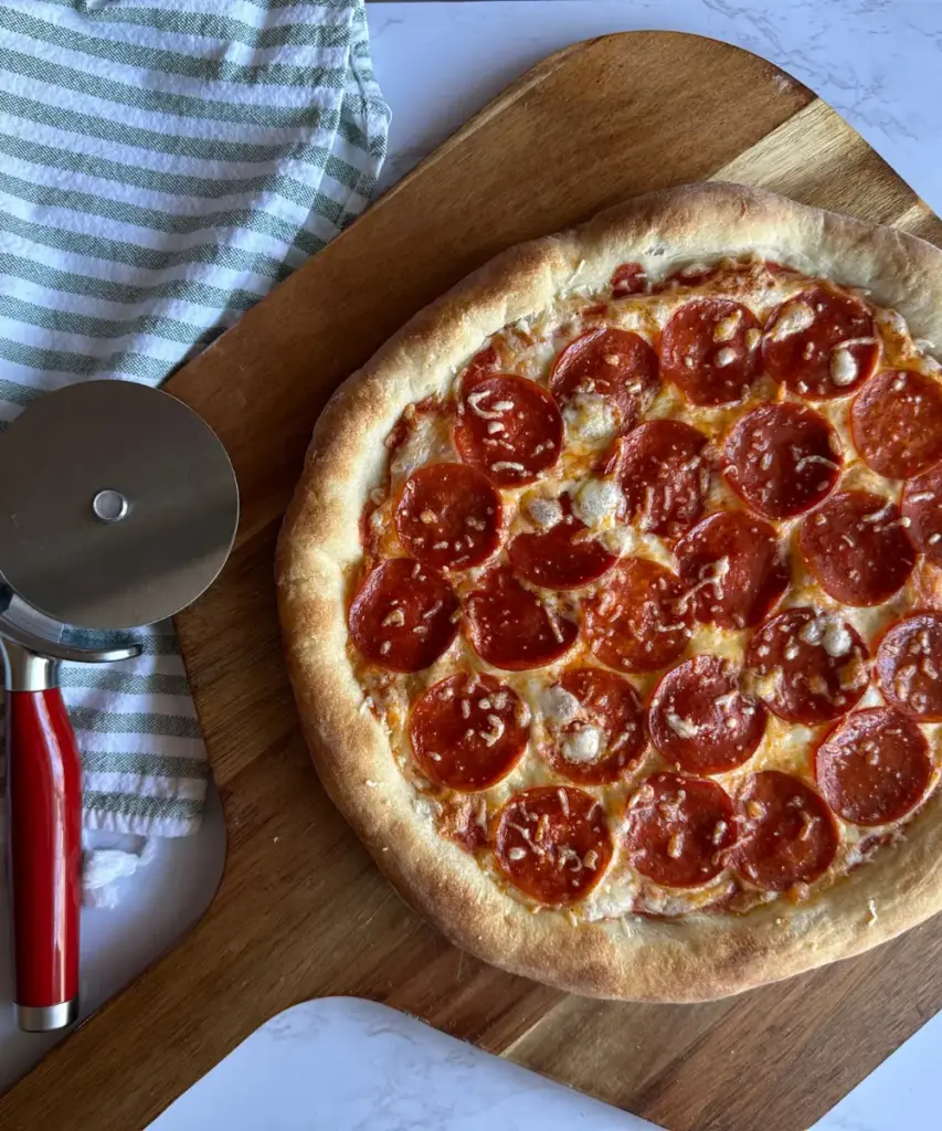 Potato Flake sourdough pizza with pepperoni toppings on pizza peel