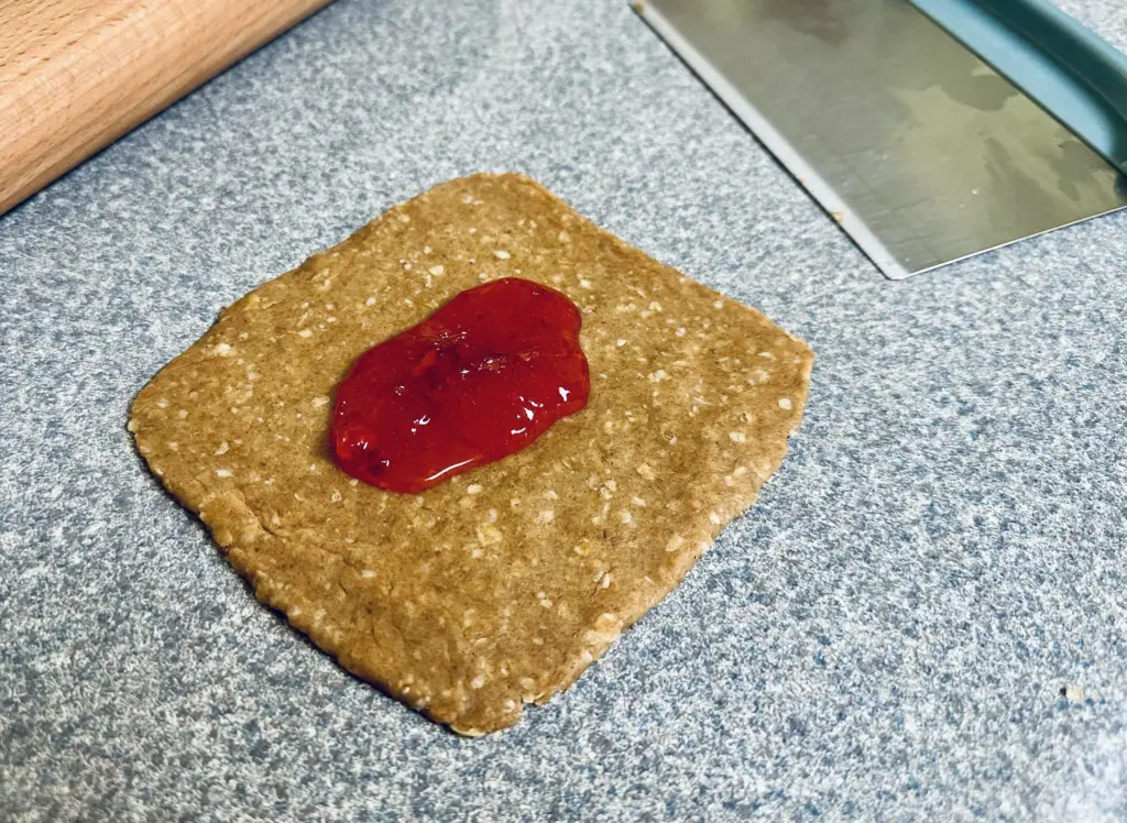 Sourdough Nutri-Grain dough rolled into a rectangle, topped with homemade jam
