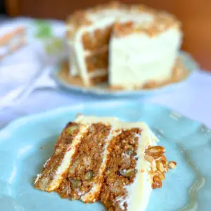 Slice of potato flake sourdough carrot cake on a blue plate