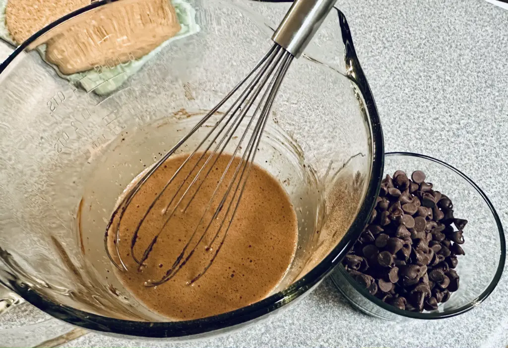 whisking in cocoa powder for the potato flake sourdough brownies