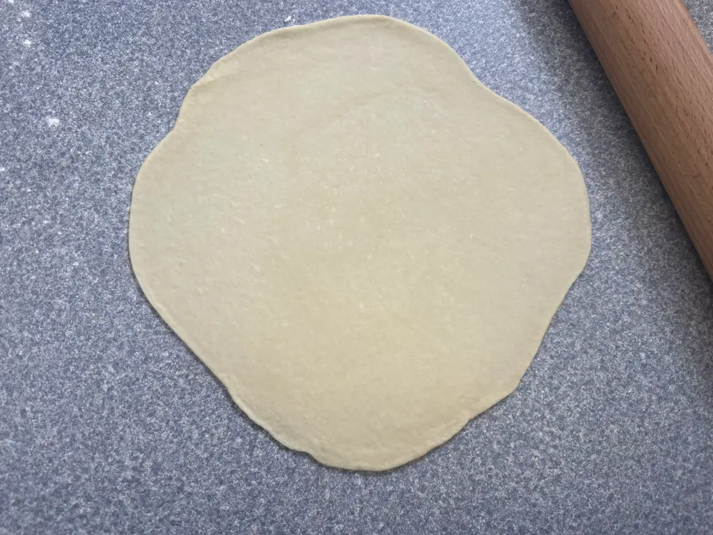 rolling out sourdough tortillas