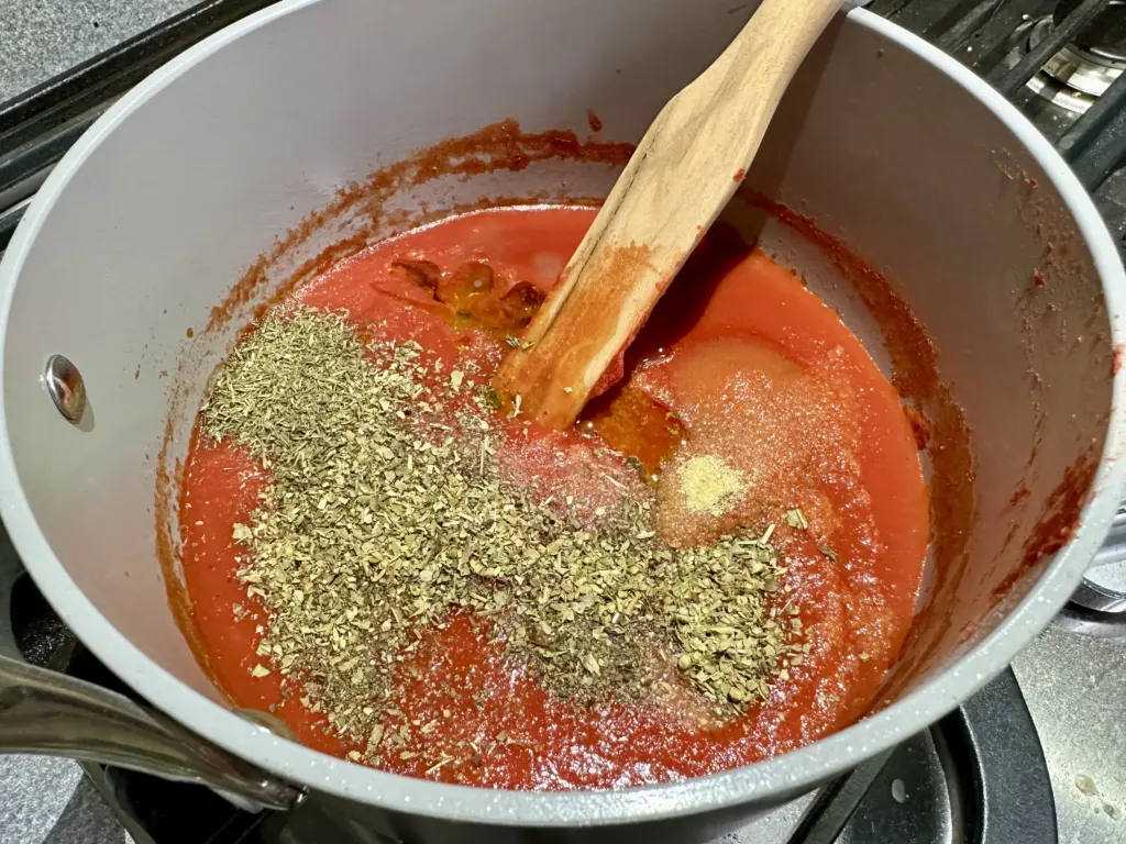 all ingredients for pizza sauce in medium saucepan