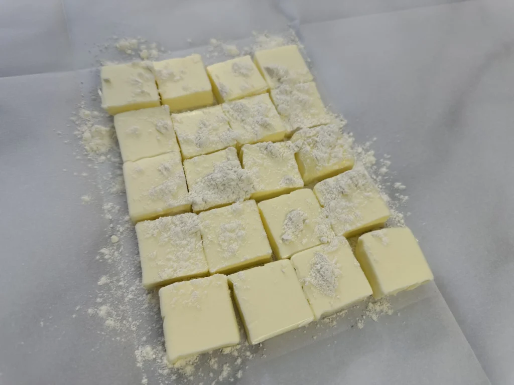 placing butter on folded parchment paper