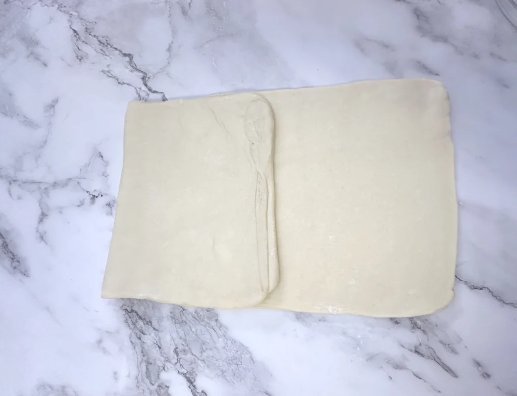 letter fold second step in laminating potato flake sourdough croissant