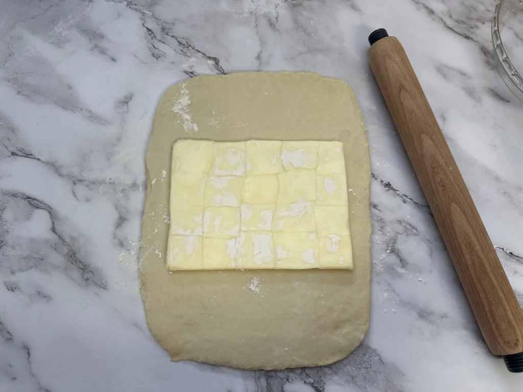 placing butter block on dough