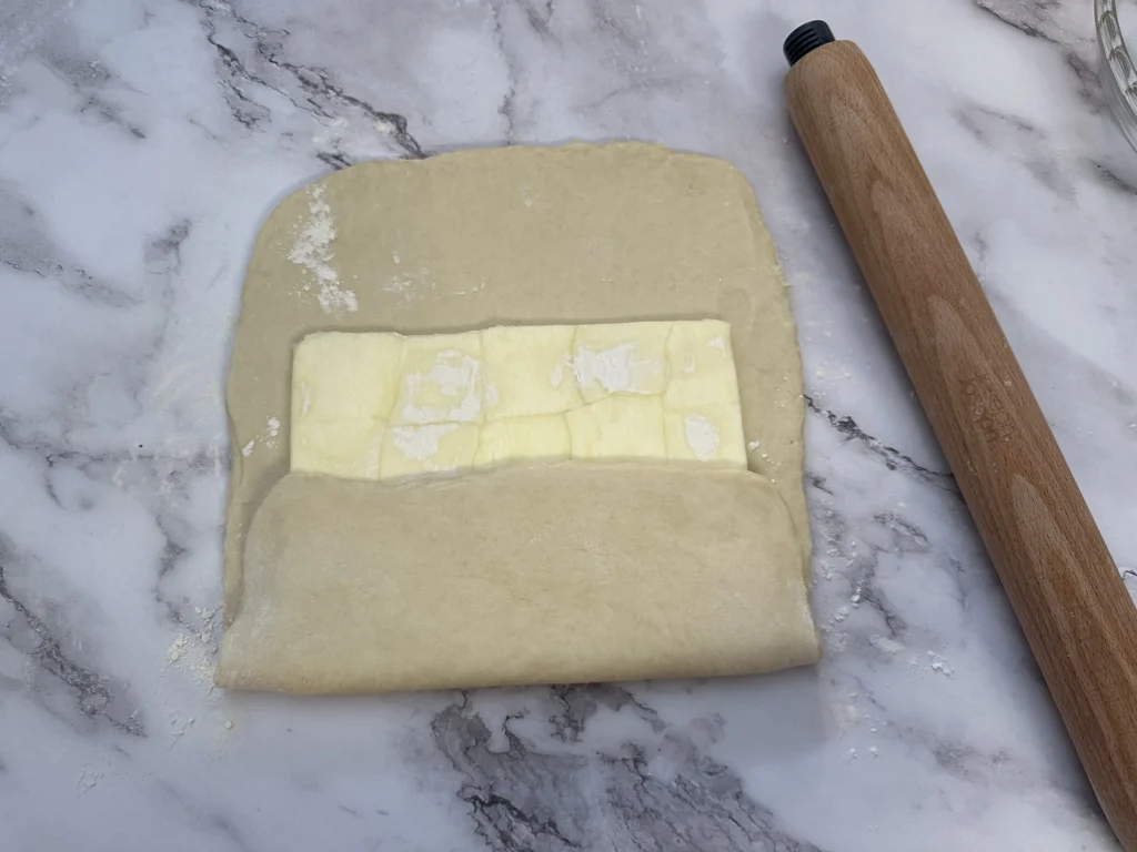 wrapping the butter block in the dough