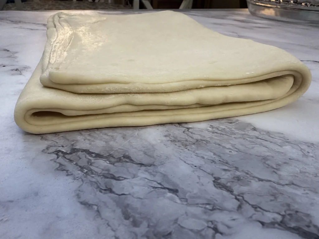 letter fold last step in laminating potato flake sourdough croissant