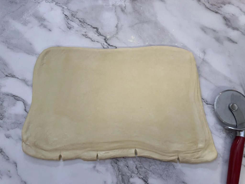 measuring and marking sourdough croissant dough