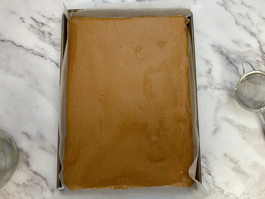 pumpkin roll batter on sheet pan