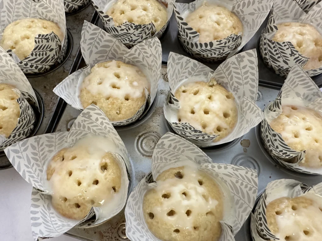 adding cream to the poked cupcakes