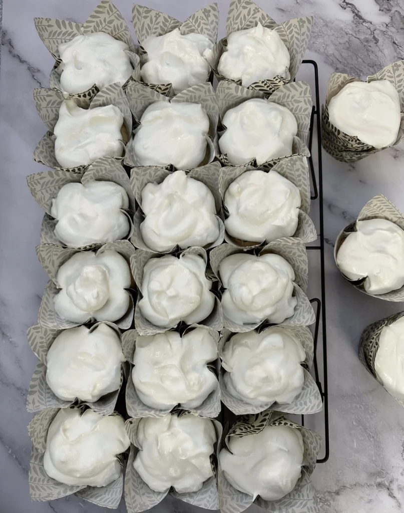 topping cupcakes with homemade whipped cream