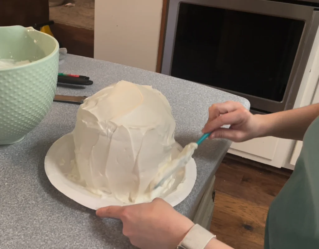adding homemade whipped topping to potato flake sourdough poke cake