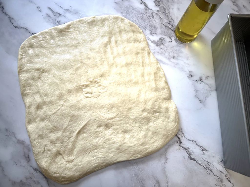 first step in shaping potato flake sourdough loaf for pullman loaf pan