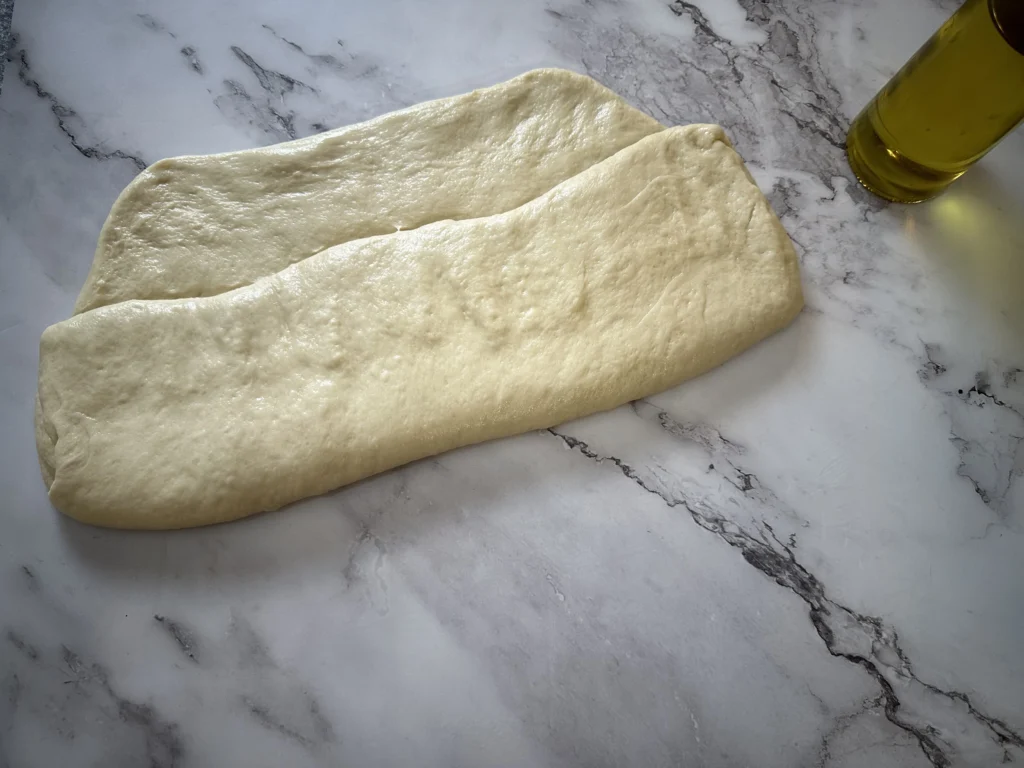 third step in shaping potato flake sourdough loaf for pullman loaf pan