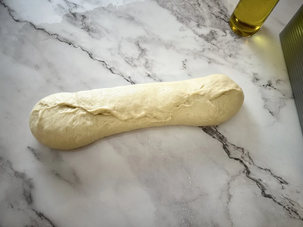 fourth step in shaping potato flake sourdough loaf for pullman loaf pan