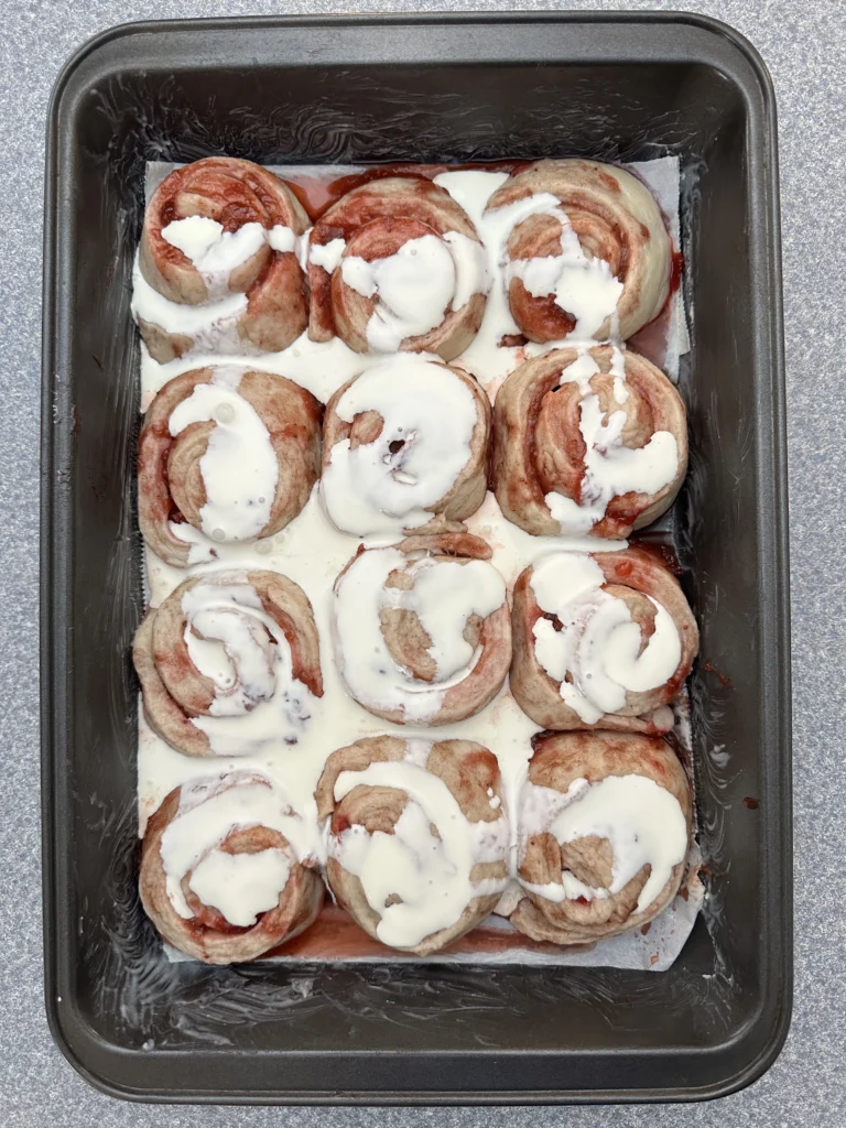 adding heavy cream to the tops of risen rolls