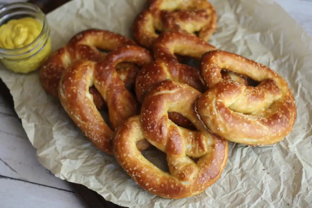 potato flake sourdough pretzels piled on baking sheet