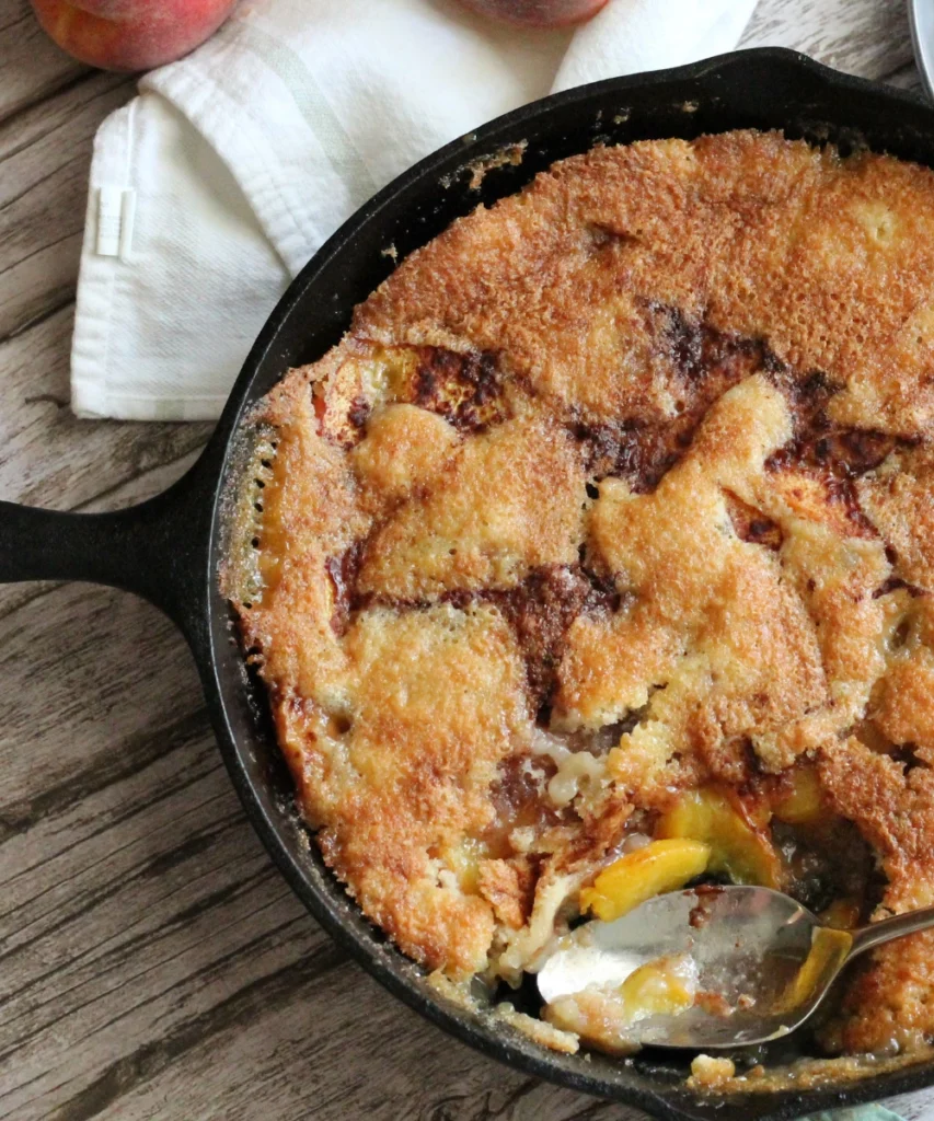 baked potato flake sourdough peach cobbler in a cast iron skillet