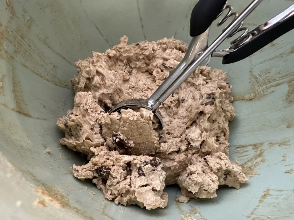 scooping potato flake sourdough oatmeal raisin cookie dough